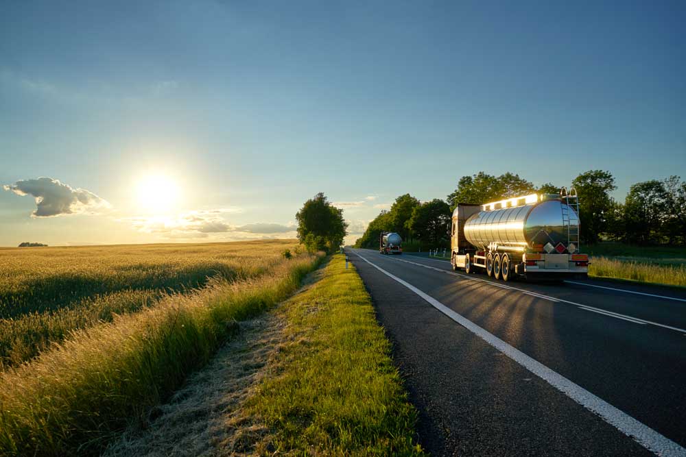 Tanker driving at sunset on a country road