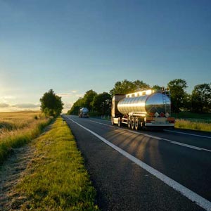 Tanker driving at sunset on a country road